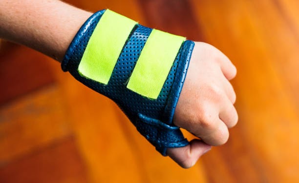 A modern cast, secured by velcro, protecting a teenage girl's broken wrist during recovery.